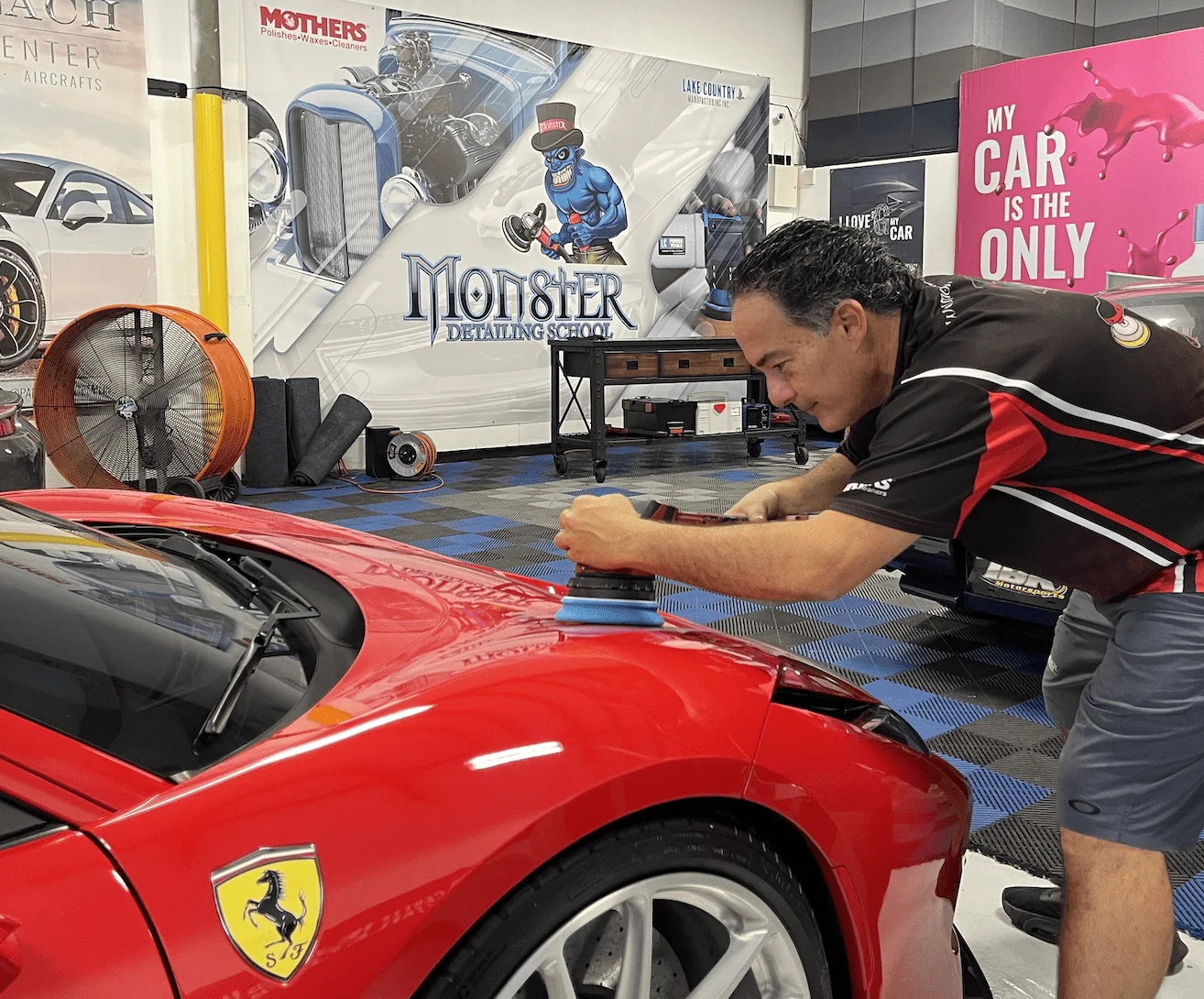 Instructor teaching polishing in auto detailing training classes