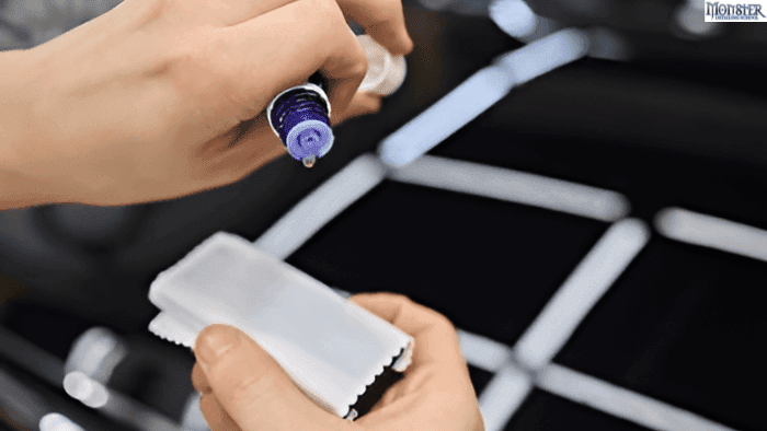 A person applying ceramic coat on a car.