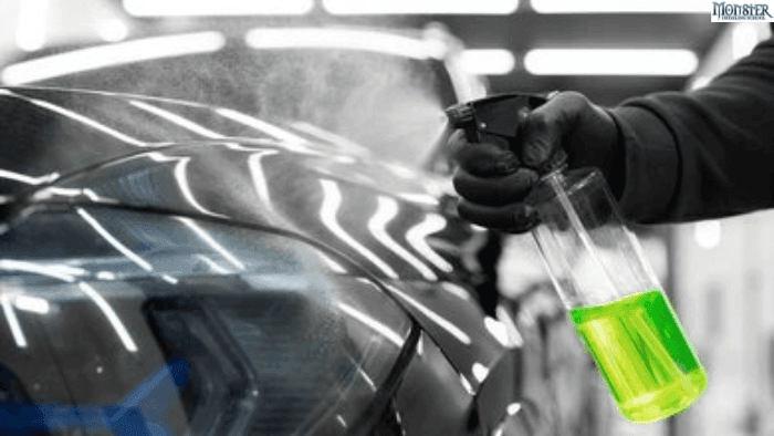 A person cleaning car with car spray.