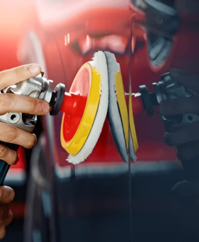 A person waxing a car with a dual action polisher.